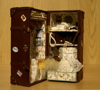 On the top shelf there is: a pearlneckless on a hook