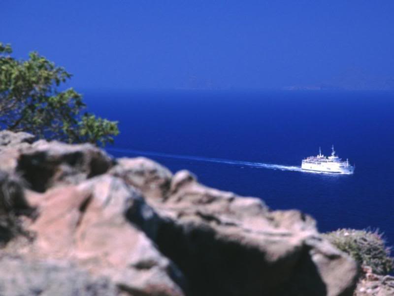 Santorini, Greece - Cruise boat standing out against th...