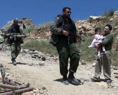 5, 26, 2000 Hizbollah guerrillas walk on the debris as ...