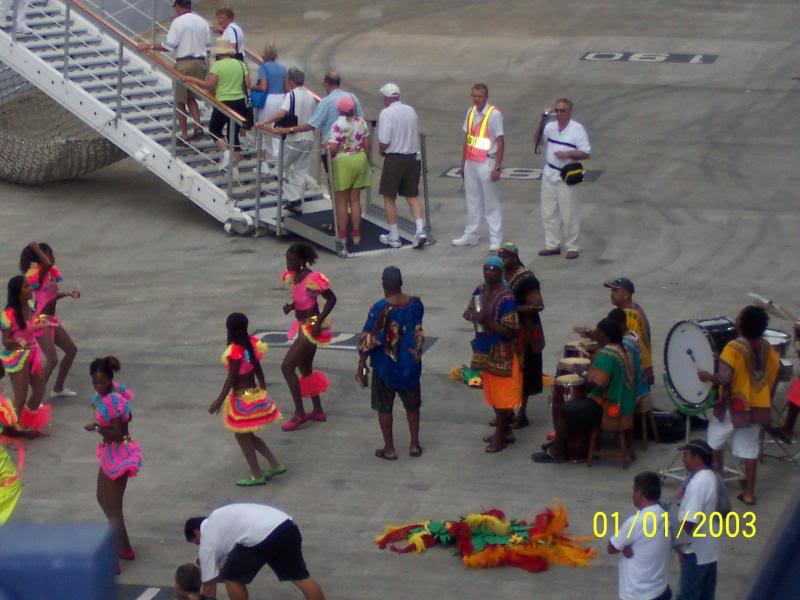 Dancers and Coral Princess passengers boarding in the b...