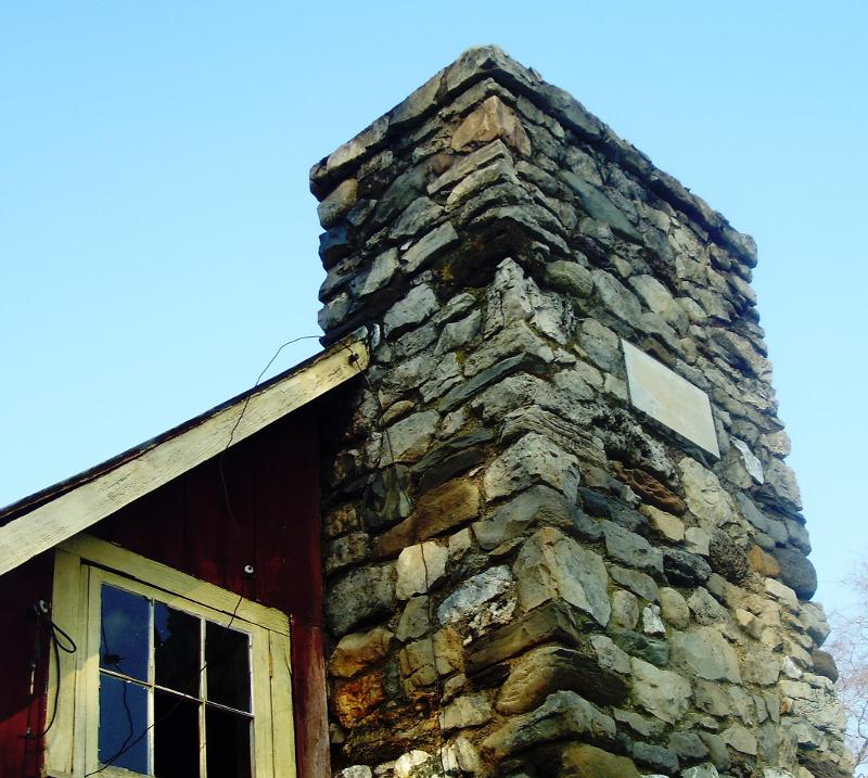 Field stone chimmey with family name plaque