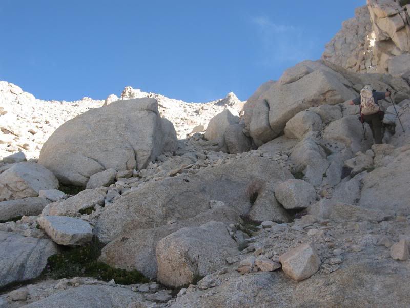 Doing our best to avoid the scree, going for boulders a...