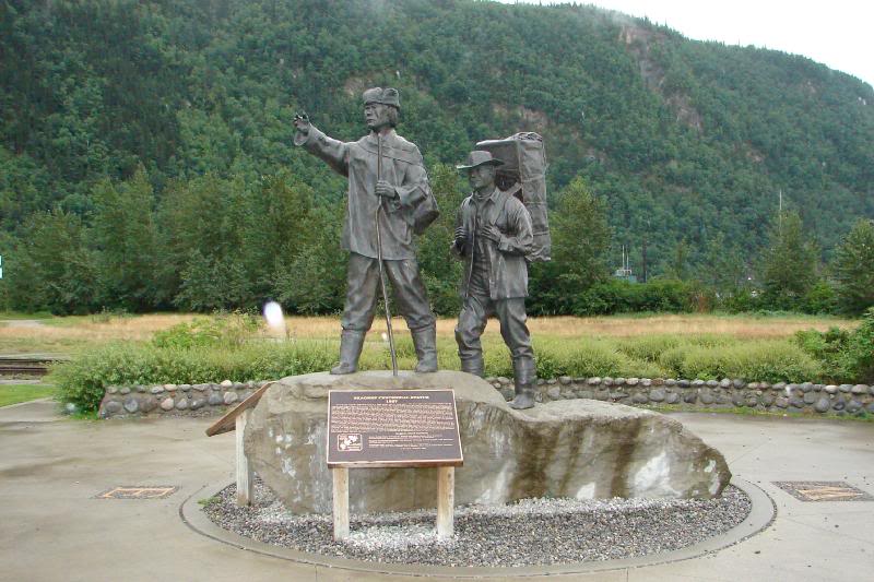 Sculpture representing a Tlingit packer and a stampeder...