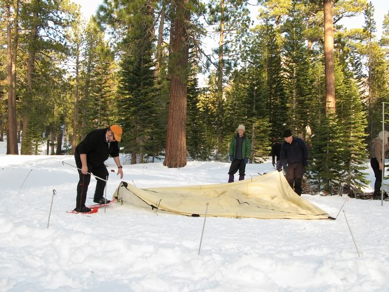 SETTING UP THE TEEPEE AT CAMP.