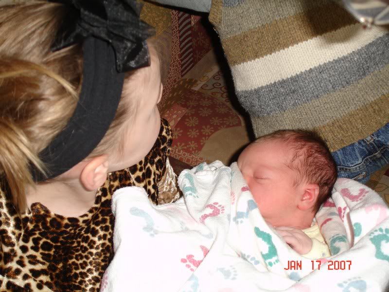 Big sister gets to hold new little sister