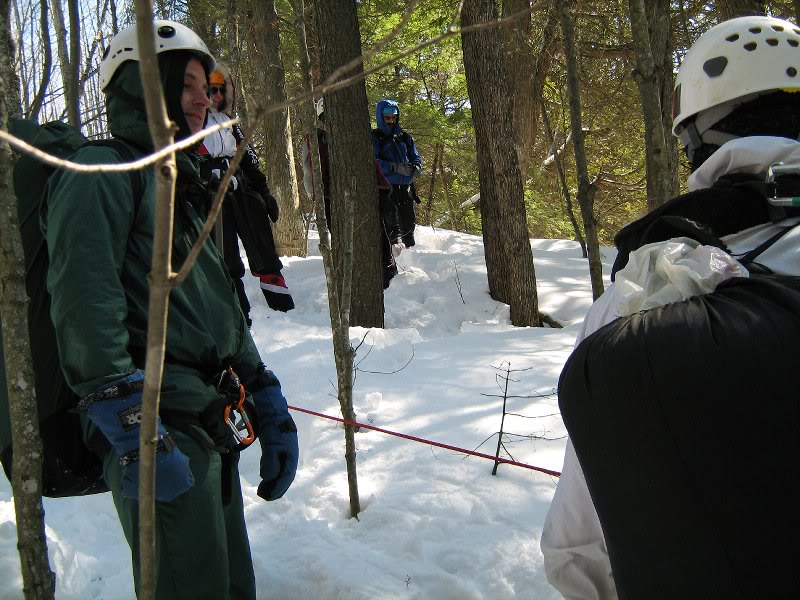 Waiting for a turn to rappel down a steep slippery slop...