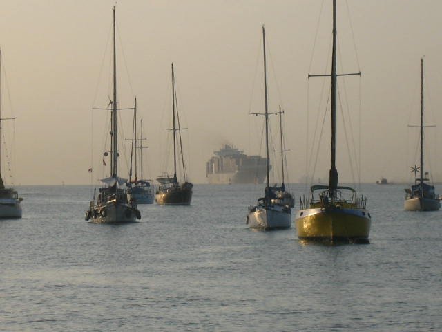 Canal contrasts-small sailboats and huge freighters