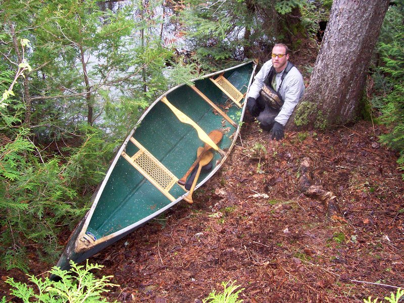 Chris with the canoe he found near Jungle Lake