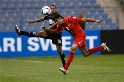 Piroozi Athletic's Heydari, right, fights for the ball ...