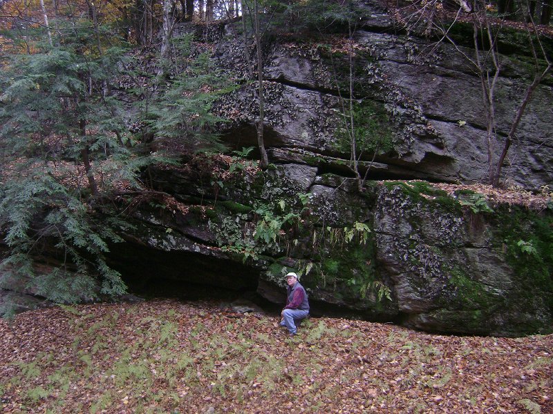 Jim in front of cliff face/cave on west side of Sykes M...