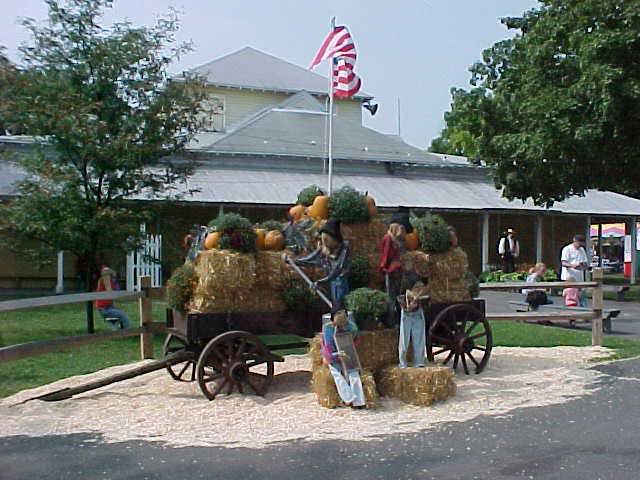deocrated wagon, in front of the big fair house